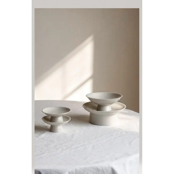 Artist Collaboration Footed Tea Snack Plates in ivory — in a room setting