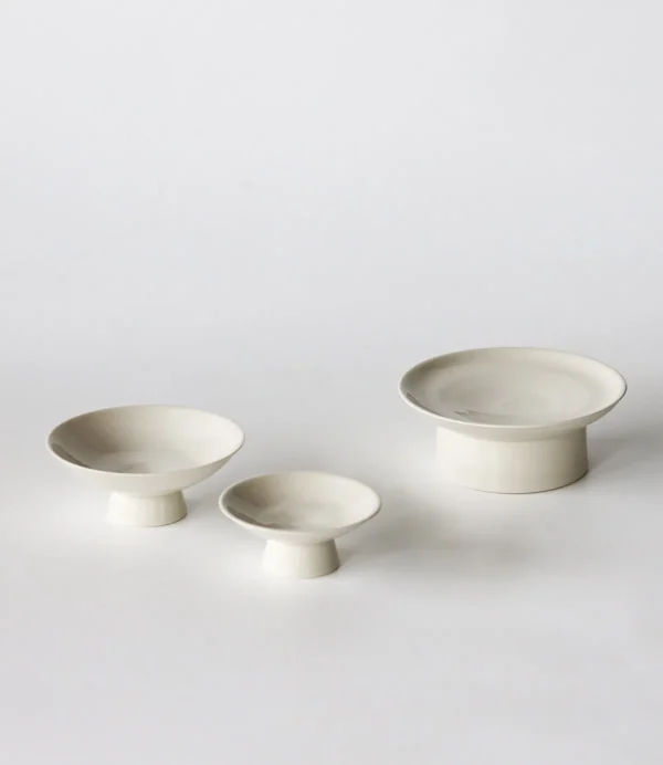 Artist Collaboration Footed Tea Snack Plates in ivory — in a room setting