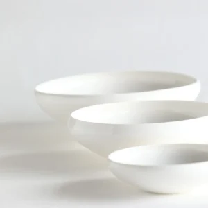 Artist Collaboration Rolled-Edge White Ceramic Bowls, Three in ivory — front view