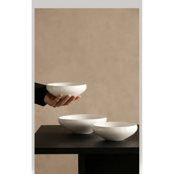 Artist Collaboration Rolled-Edge White Ceramic Bowls, Three in ivory — in a room setting