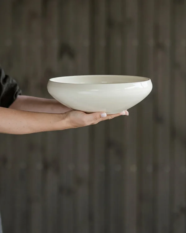 Artist Collaboration Rolled-Edge White Ceramic Bowls, Three in ivory — in a room setting