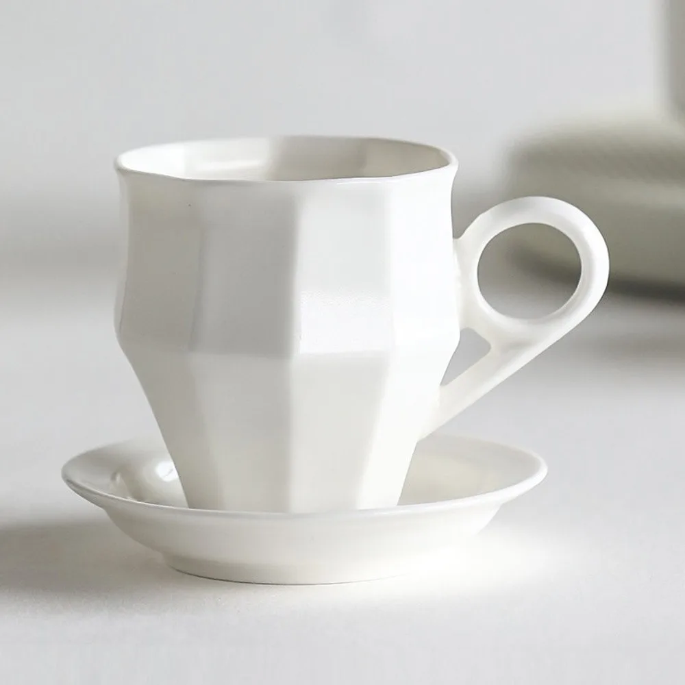 Artist Collaboration Faceted White Ceramic Coffee Mug in ivory — front view