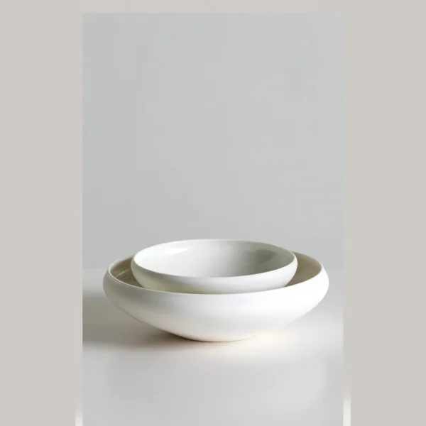 Artist Collaboration Plain Flat Round Shallow Bowl, Small in ivory — in a room setting