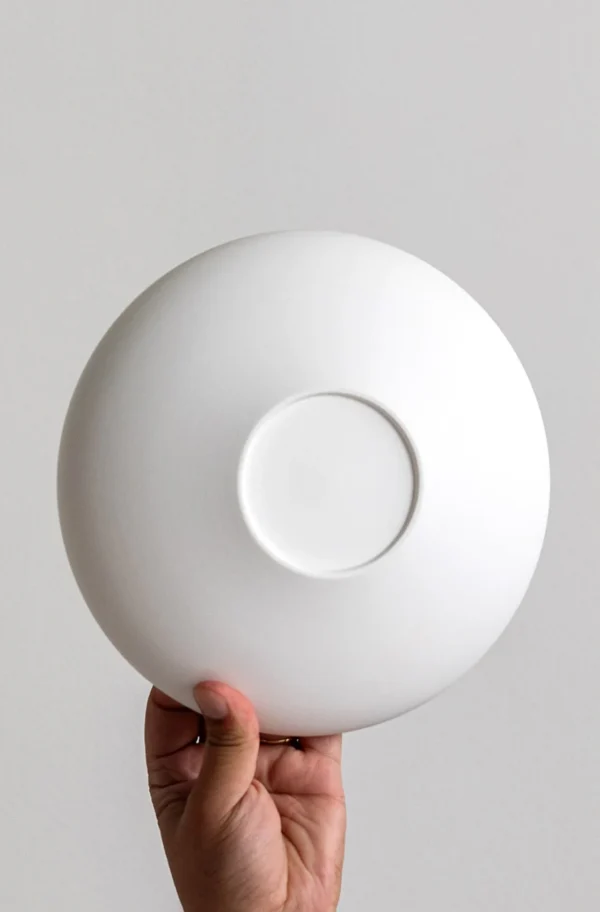 Artist Collaboration Plain Flat Round Shallow Bowl, Small in ivory — in a room setting