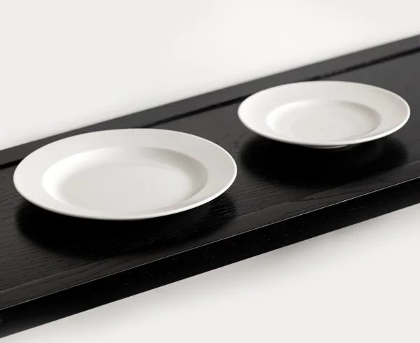Artist Collaboration Plain Wide-Rim White Flat Plates in ivory — in a room setting