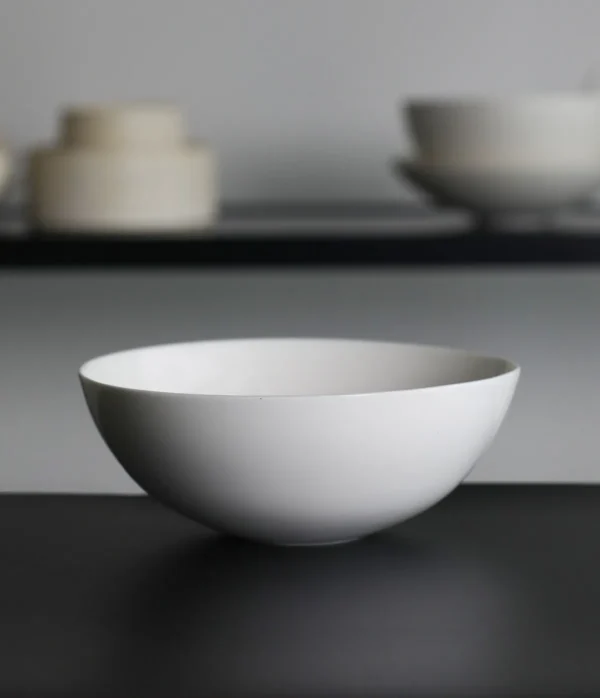 Artist Collaboration Pure White Ceramic Conical Bowl in ivory — in a room setting