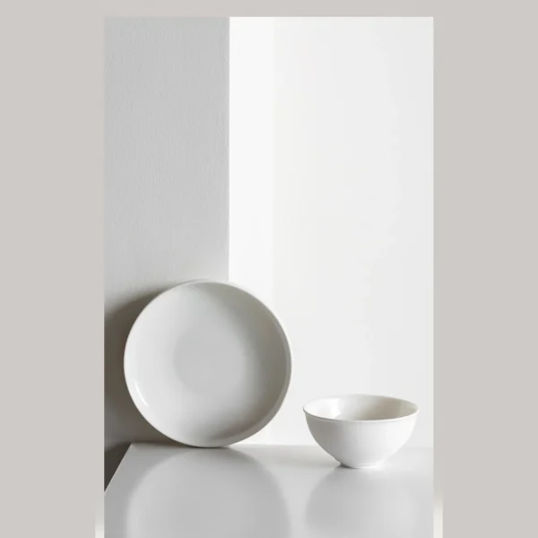 Artist Collaboration Soft-Glow White Porcelain Bowls and Cup in ivory — in a room setting