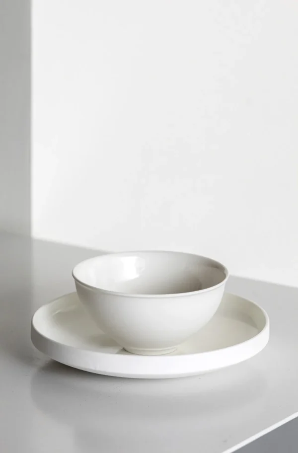 Artist Collaboration Soft-Glow White Porcelain Bowls and Cup in ivory — in a room setting