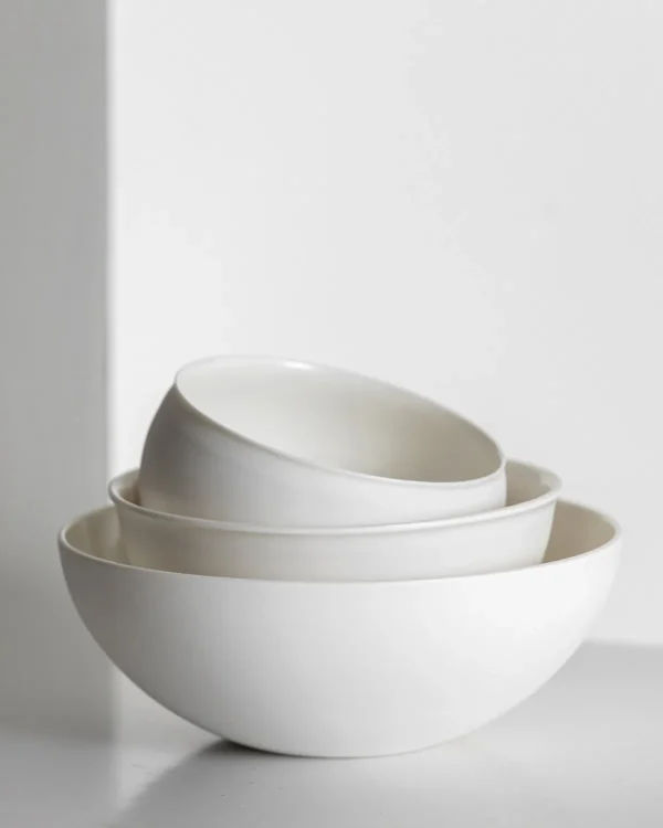 Artist Collaboration Soft-Glow White Porcelain Bowls and Cup in ivory — in a room setting