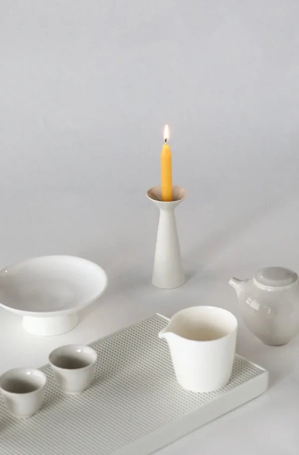 Artist Collaboration White Ceramic Candle Holder, Tapered in ivory — in a room setting