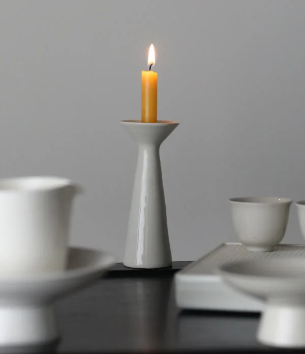 Artist Collaboration White Ceramic Candle Holder, Tapered in ivory — in a room setting