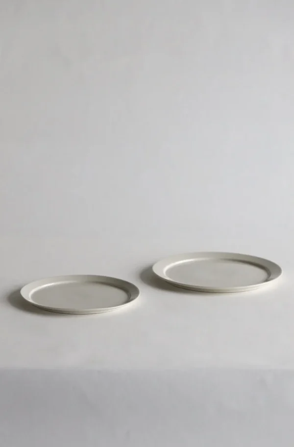 Artist Collaboration White Porcelain Flat Plates and Bowl in ivory — in a room setting