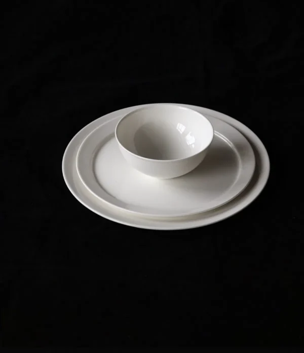 Artist Collaboration White Porcelain Flat Plates and Bowl in ivory — in a room setting