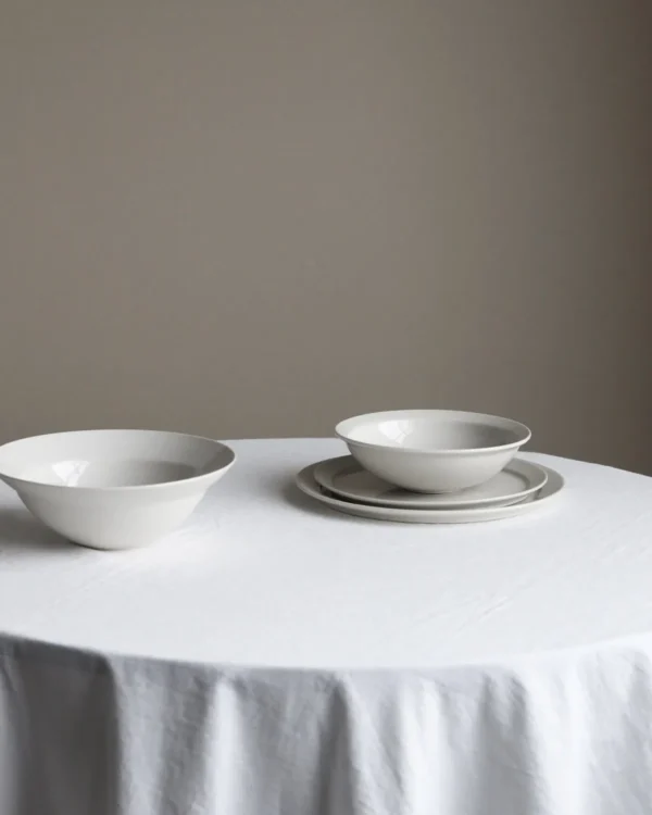 Artist Collaboration White Porcelain Flat Plates and Bowl in ivory — in a room setting