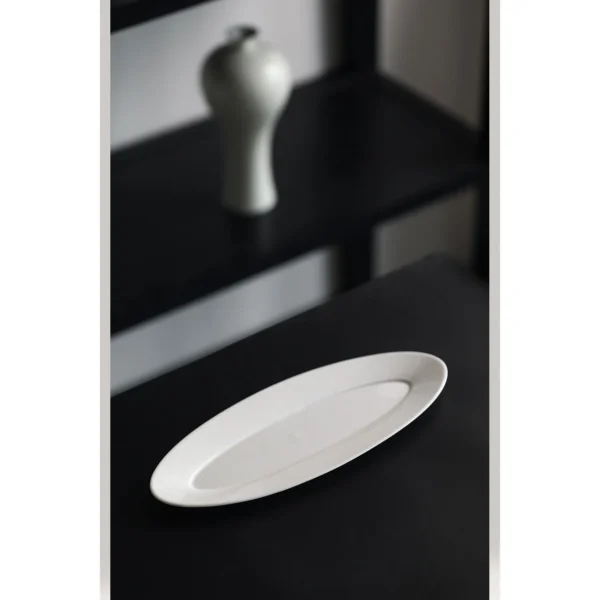 Artist Collaboration White Porcelain Leaf Boat Plate in ivory — in a room setting