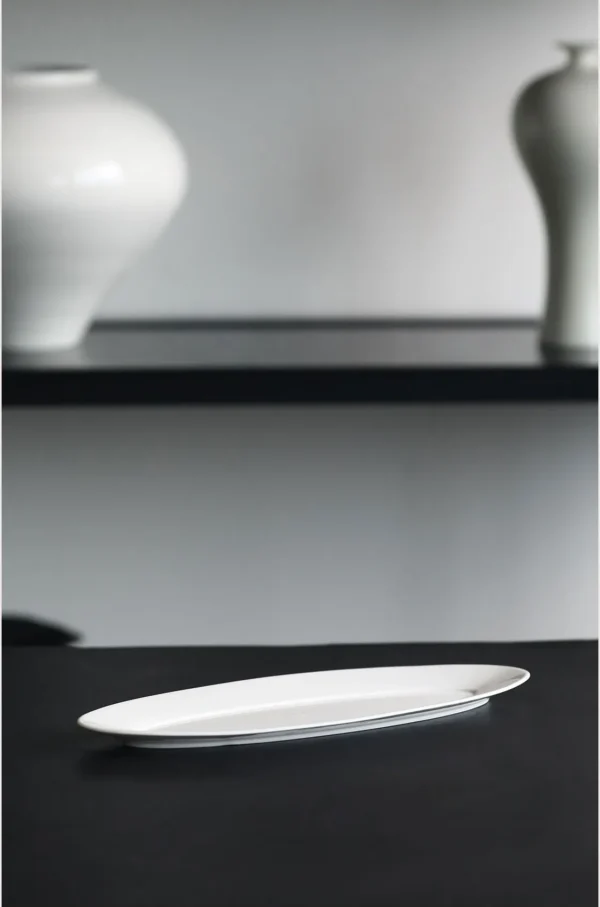 Artist Collaboration White Porcelain Leaf Boat Plate in ivory — in a room setting