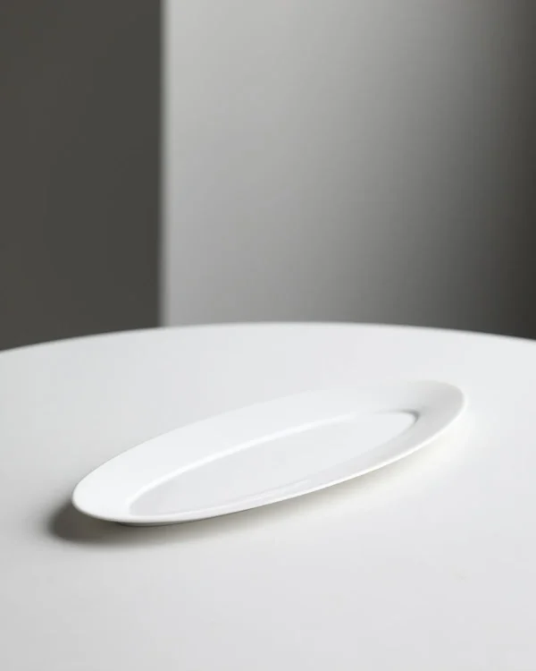 Artist Collaboration White Porcelain Leaf Boat Plate in ivory — in a room setting