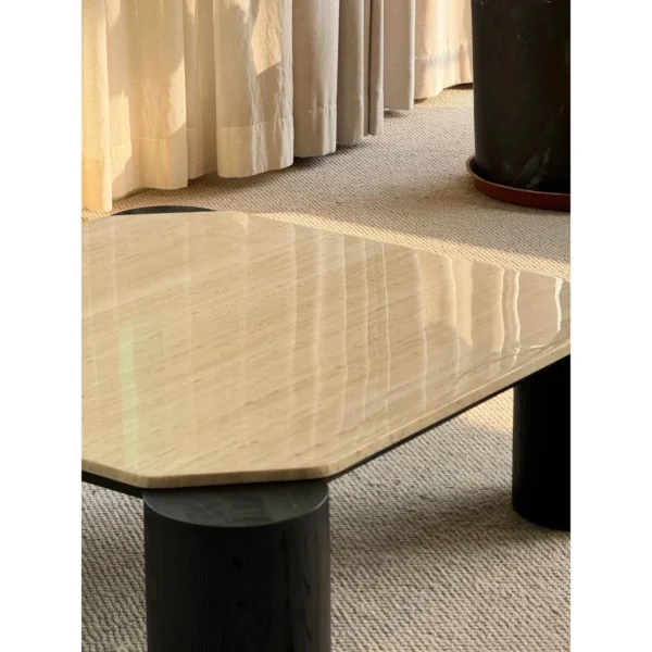 Super White Travertine Coffee Table on Black Cylinder Legs in oatmeal — in a room setting