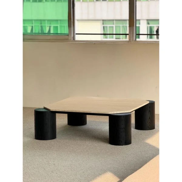 Super White Travertine Coffee Table on Black Cylinder Legs in oatmeal — in a room setting