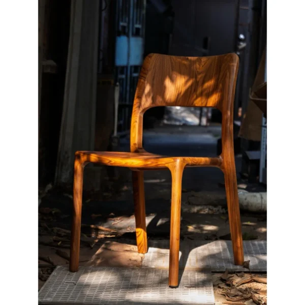 Burmese Teak Sculpted Dining Chair with Open Back in clay — in a room setting