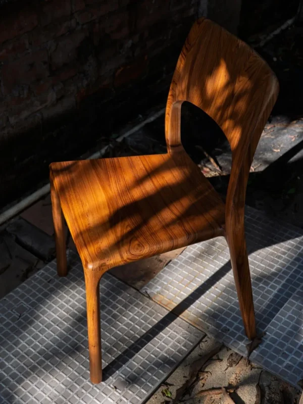 Burmese Teak Sculpted Dining Chair with Open Back in clay — in a room setting