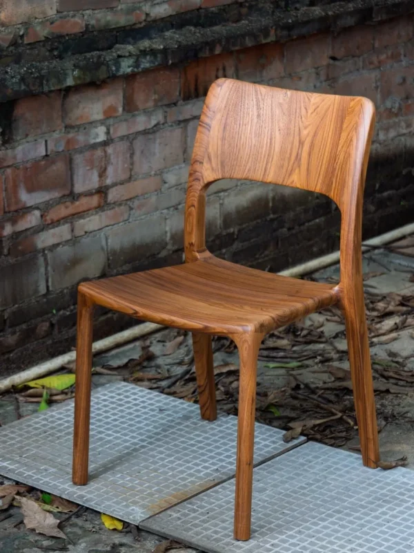 Burmese Teak Sculpted Dining Chair with Open Back in clay — in a room setting