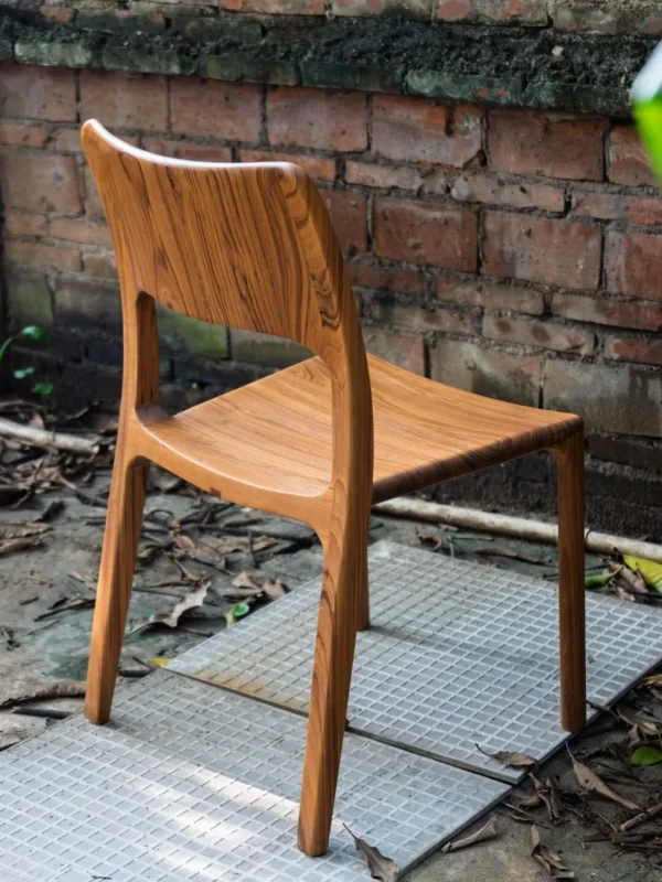 Burmese Teak Sculpted Dining Chair with Open Back in clay — in a room setting