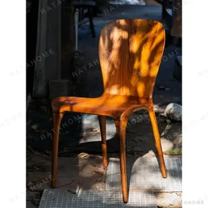 Sculpted Burmese Teak Chair with Grain Back in clay — in a room setting