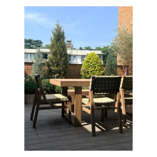 Teak Outdoor Dining Table with Bench and Webbed Chairs in natural oak — in a room setting