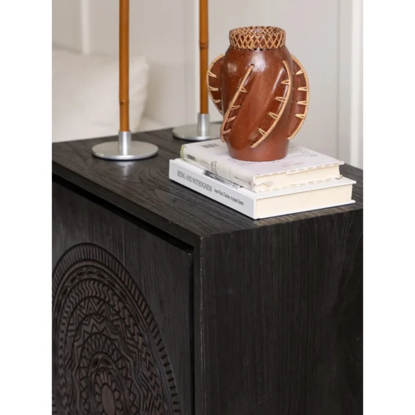 Hena Teak Small Side Cabinet with Carved Mandala Door, 60 cm in black — in a room setting