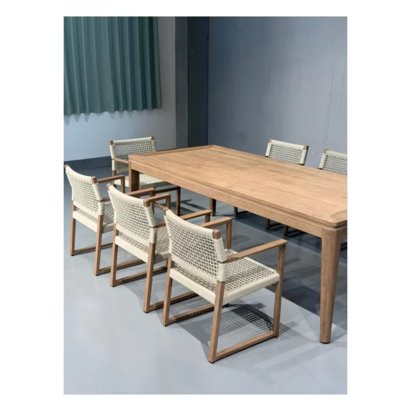 Burmese Teak Outdoor Dining Set with Webbed Armchairs in natural oak — in a room setting
