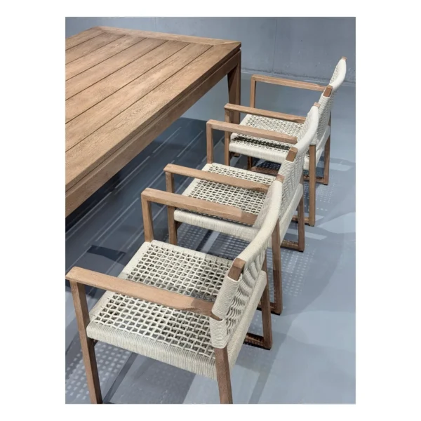 Burmese Teak Outdoor Dining Set with Webbed Armchairs in natural oak — in a room setting