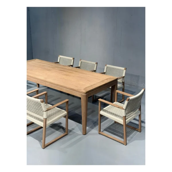 Burmese Teak Outdoor Dining Set with Webbed Armchairs in natural oak — in a room setting