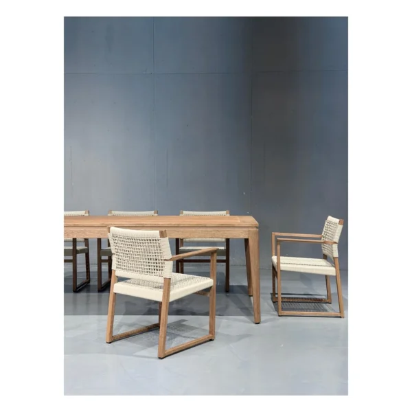Burmese Teak Outdoor Dining Set with Webbed Armchairs in natural oak — in a room setting