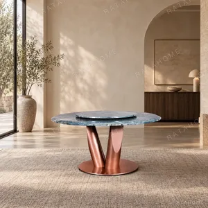 Teal Marble Round Dining Table on Rose Gold Curved Base in blue — in a room setting