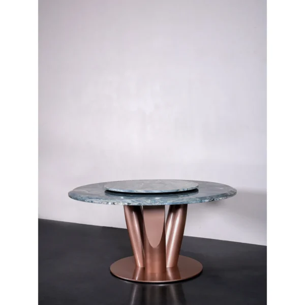 Teal Marble Round Dining Table on Rose Gold Curved Base in blue — in a room setting