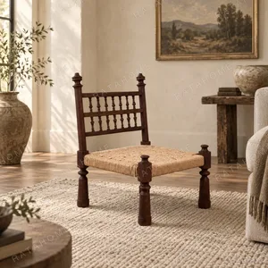 Terra Low Carved Wood Chair with Woven Seat in clay — in a room setting