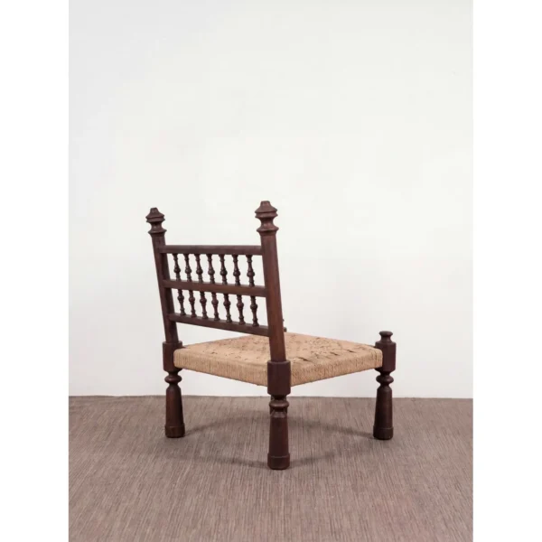 Terra Low Carved Wood Chair with Woven Seat in clay — in a room setting