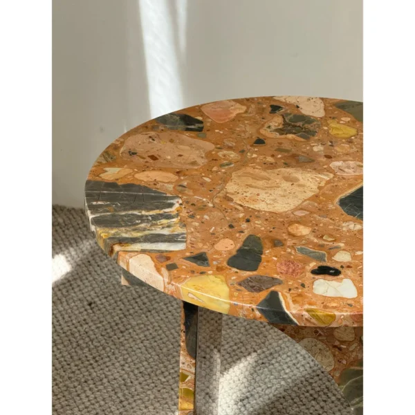 Warm Terrazzo Marble Side Table on Sculpted Slab Base in clay — in a room setting
