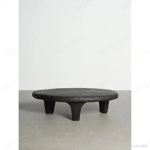 Distressed Carved Black Walnut Coffee Table, 130 x 80 cm in black — in a room setting