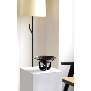 Three-Legged Black Ceramic Art Fruit Plate with Ring Pattern in black — in a room setting