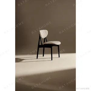 Leila Black Ash Dining Chair with Bouclé Cushions in black — in a room setting