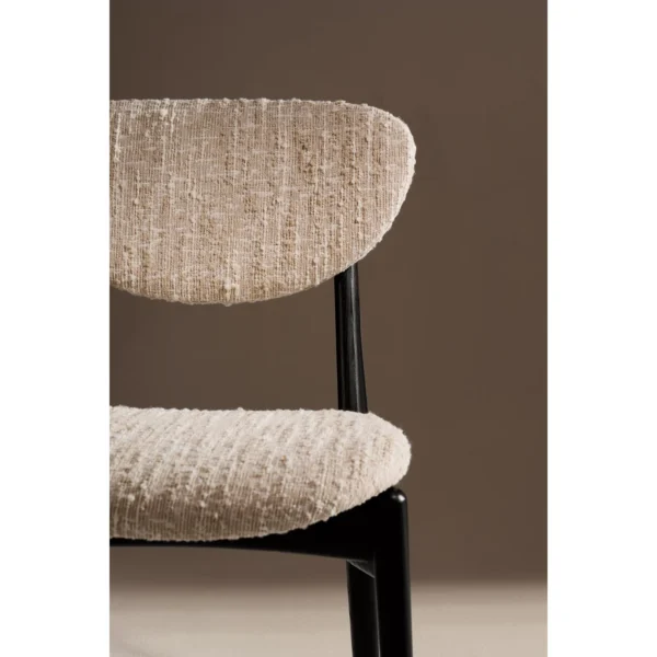 Leila Black Ash Dining Chair with Bouclé Cushions in black — in a room setting