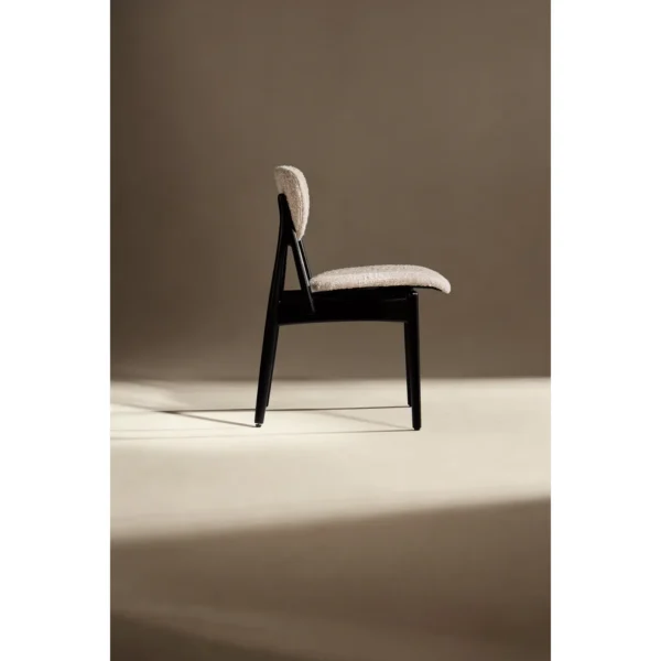 Leila Black Ash Dining Chair with Bouclé Cushions in black — in a room setting
