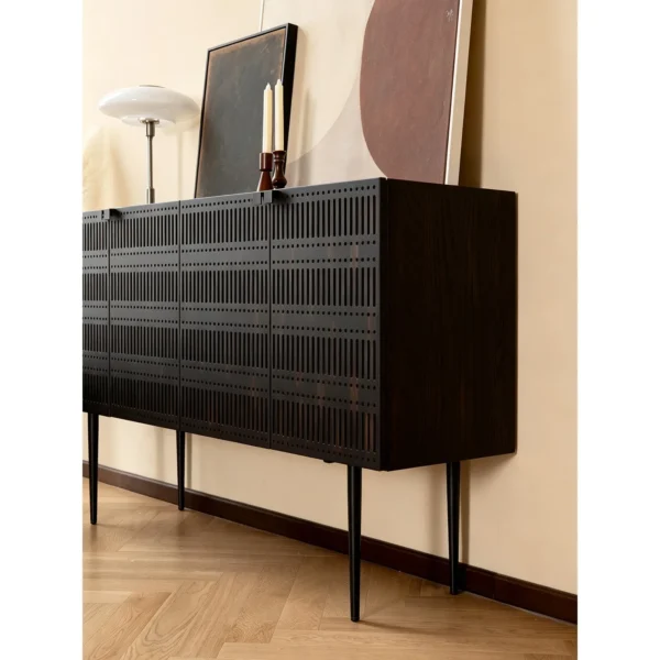 Dark Cloud Perforated Cabinet on Tall Black Legs in black — in a room setting