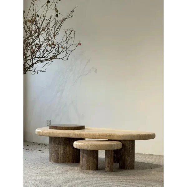 Travertine Nesting Coffee Table Pair on Cylinder Legs in sand — in a room setting