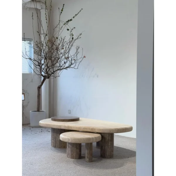 Travertine Nesting Coffee Table Pair on Cylinder Legs in sand — in a room setting