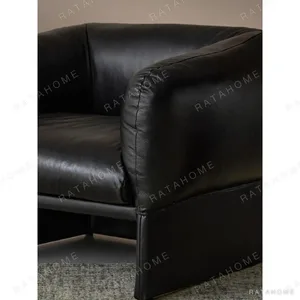 Tulip Black Leather Armchair with Goose Down Cushions in black — in a room setting
