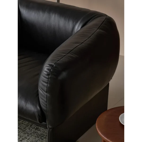 Tulip Black Leather Armchair with Goose Down Cushions in black — in a room setting