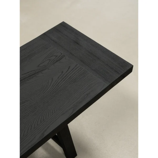 Ubud Black Wood Bench with Crossed Legs in black — in a room setting